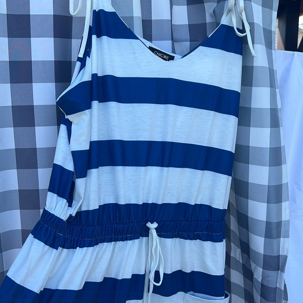 Worn once swim cover up. Tie shoulders, adjustable waist, two pockets